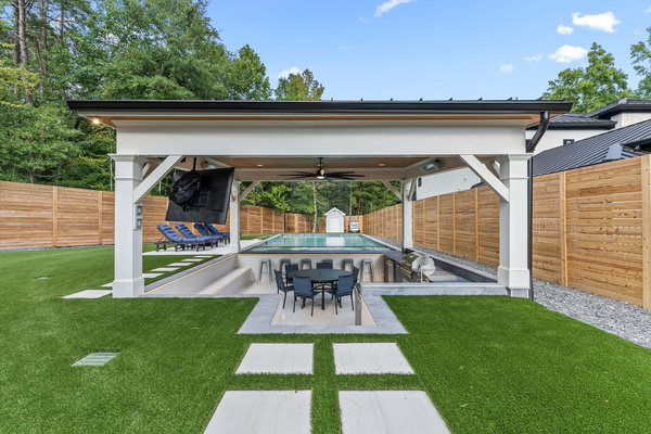 Stunning back yard with outdoor kitchen and dining area, large screen tv, surround sound, heat lamps, heated spa and pool! 