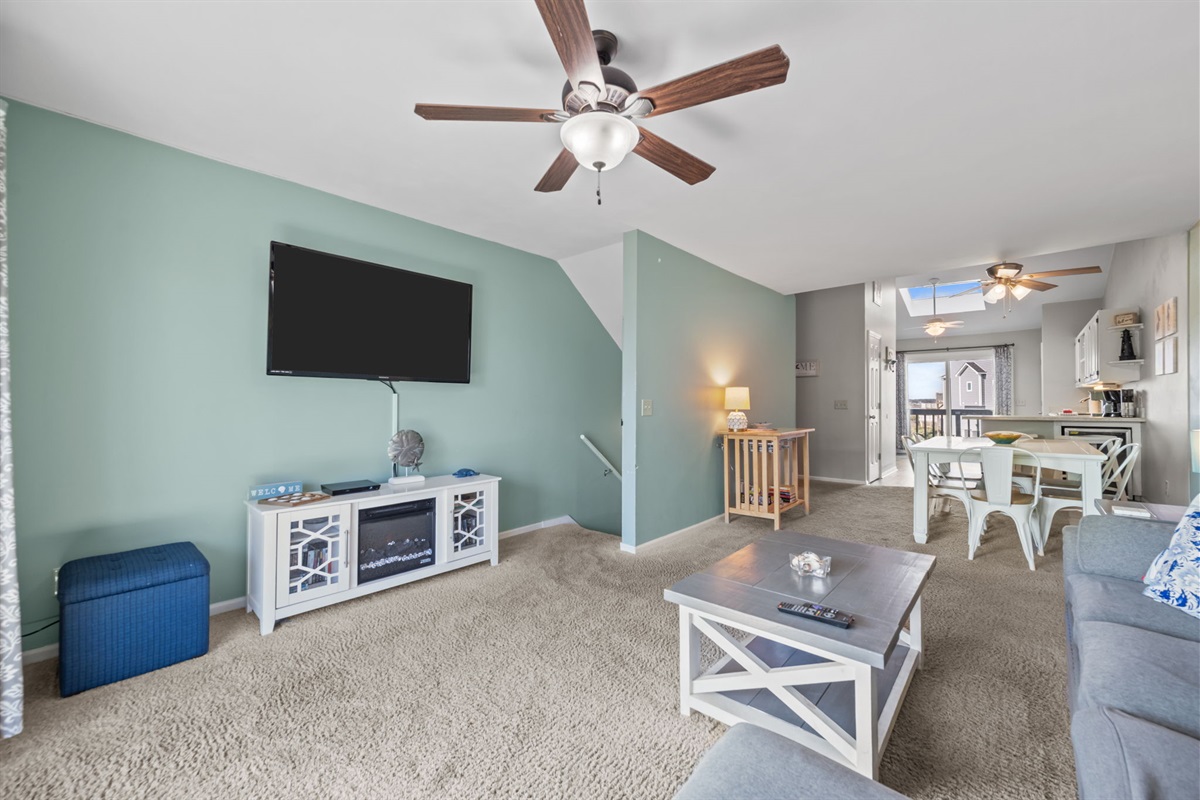 Open concept layout connecting the living room, dining space, and kitchen so everyone can stay together after a day at the beach