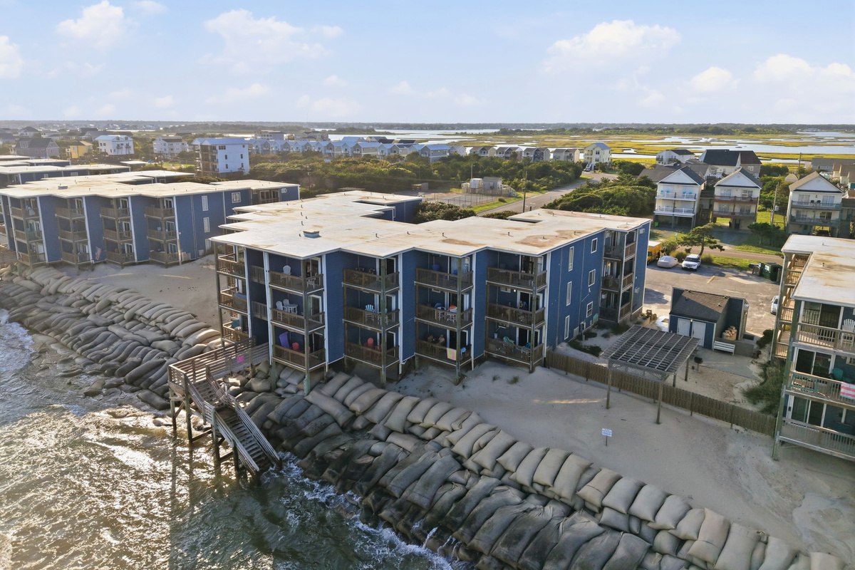A panoramic aerial view highlighting the peaceful surroundings of Topsail Reef, where oceanfront living meets the beauty of Topsail Island&rsquo;s coastline and nearby inlet