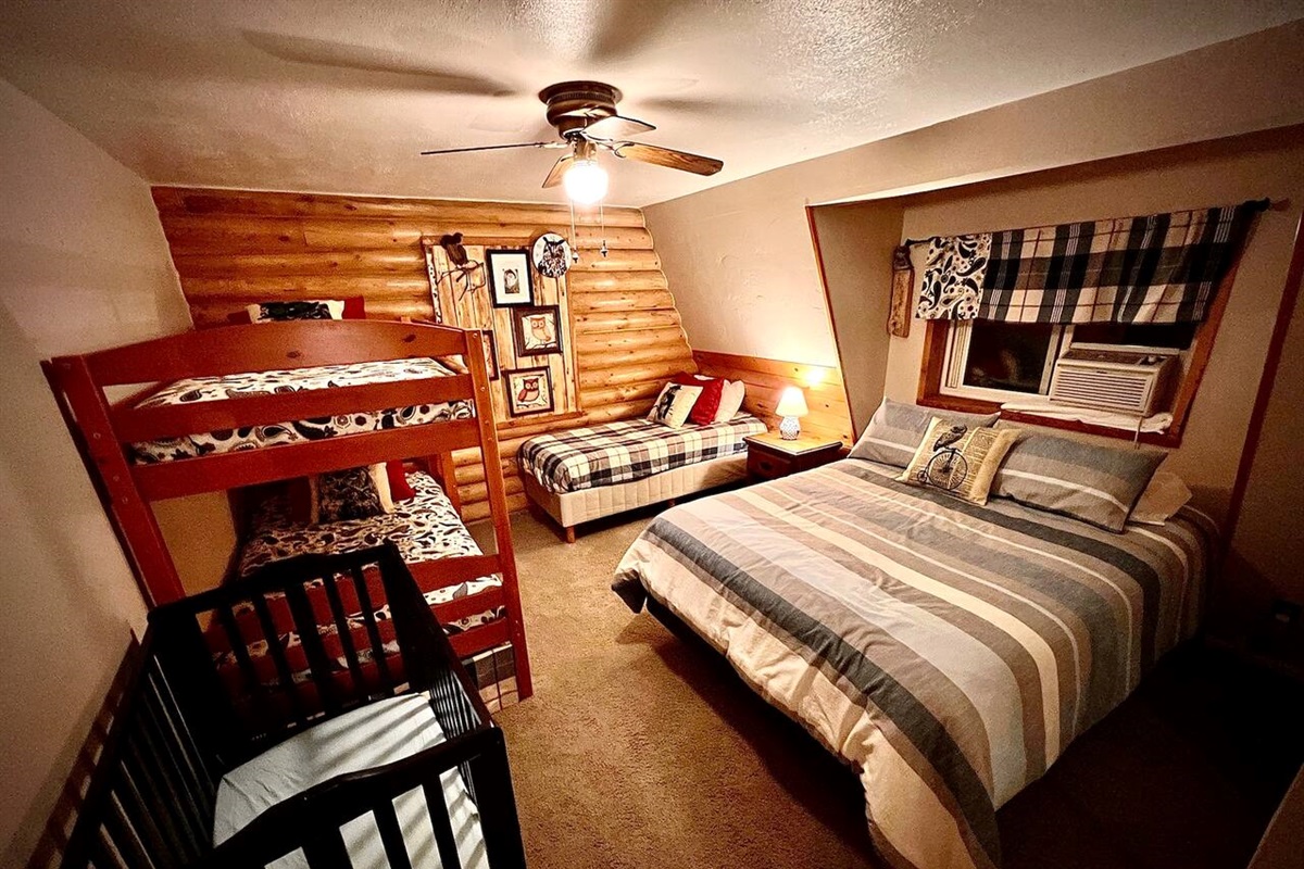 It's a Hoot, located on the 2nd floor, sleeps 5 with a queen bed, a bunk and a twin.  There is also another porta crib in this area.