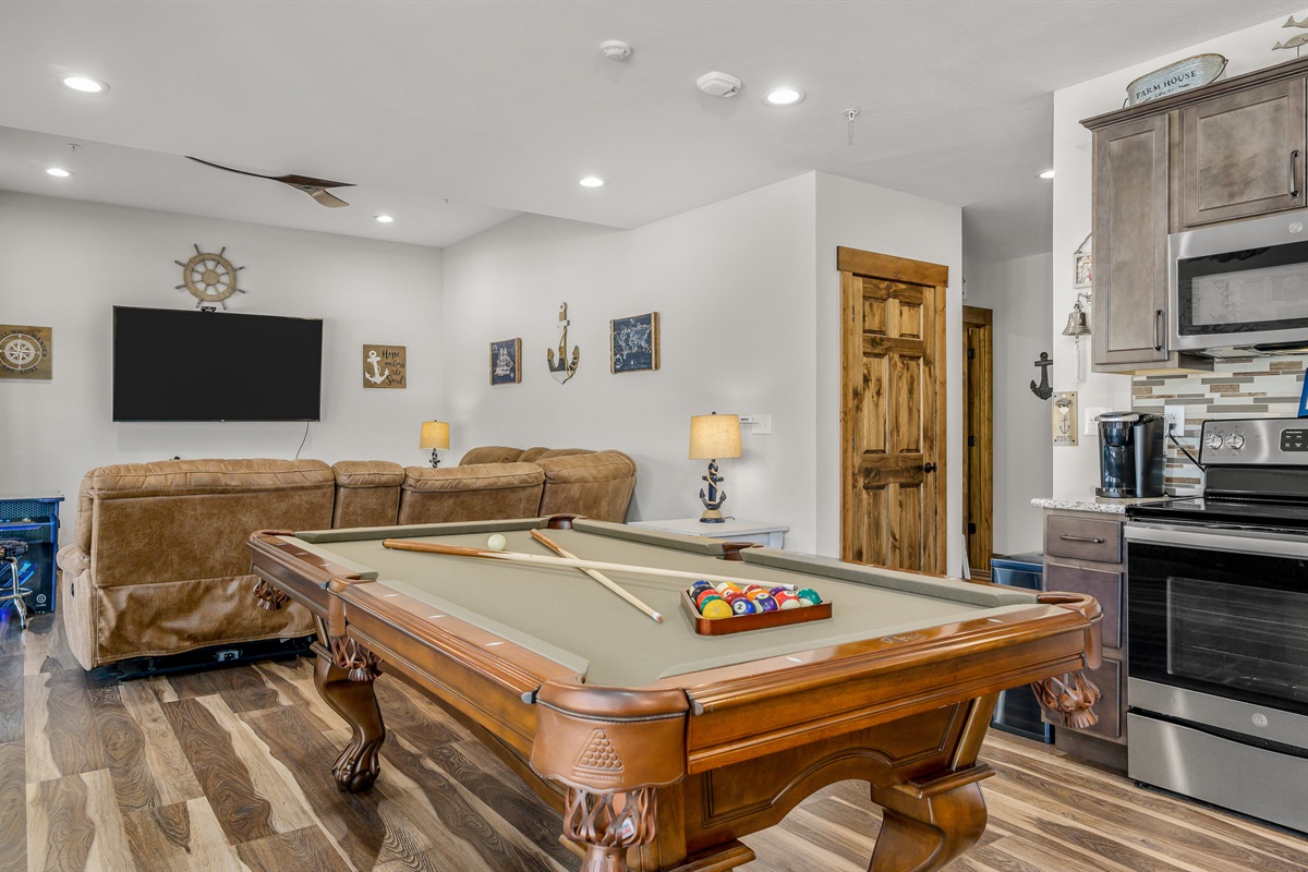 Game area with pool table and 70" smart TV