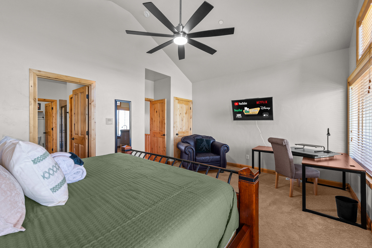 Primary suite offers a dedicated workspace and comfortable seating area.
