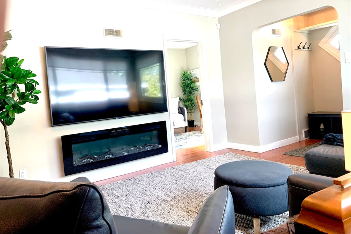 Bright Main Living Room with 75″ Smart TV & Cozy Fireplace