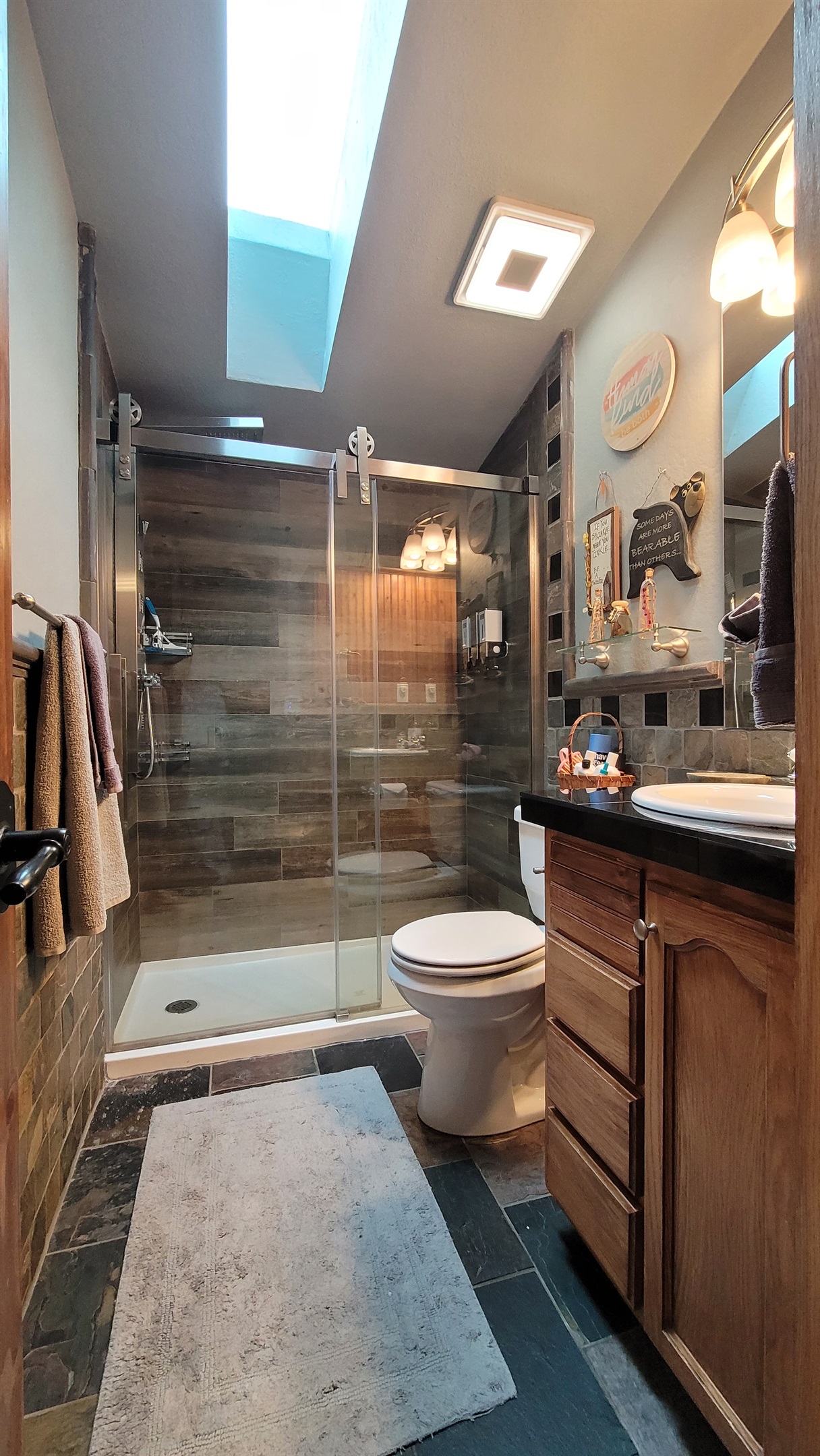 Waterfall shower in guest bathroom next to King guest room and bunk bed room