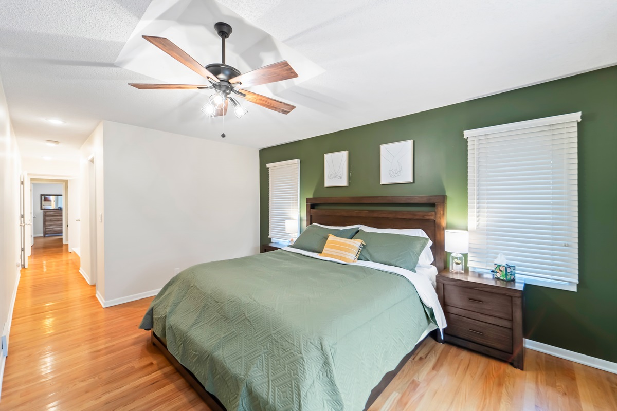 The king size bed room is tucked away from the hustle and bustle of the home, tucked in a quiet area of the home.