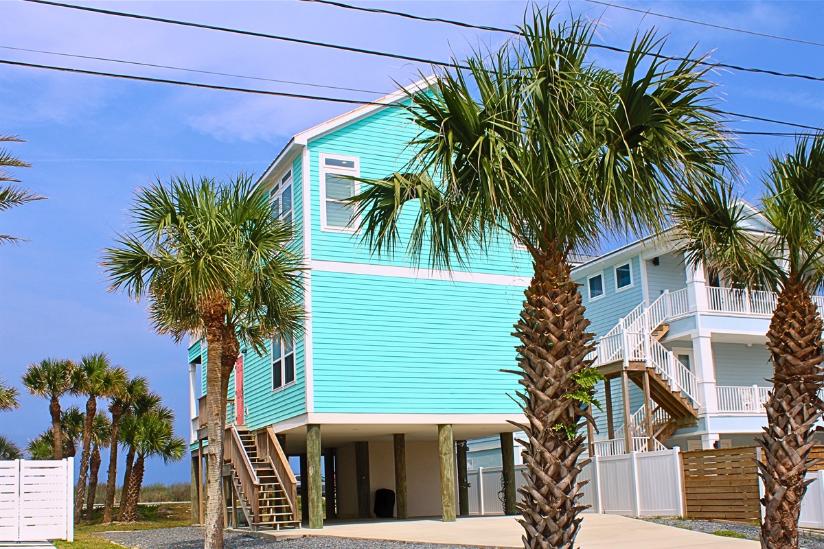 Exterior: Bright aqua exterior with ample parking, just steps from Flagler Beach's sandy shores!