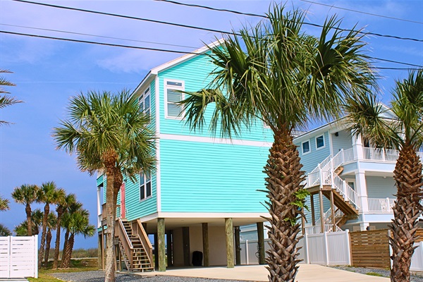 Exterior: Bright aqua exterior with ample parking, just steps from Flagler Beach's sandy shores!
