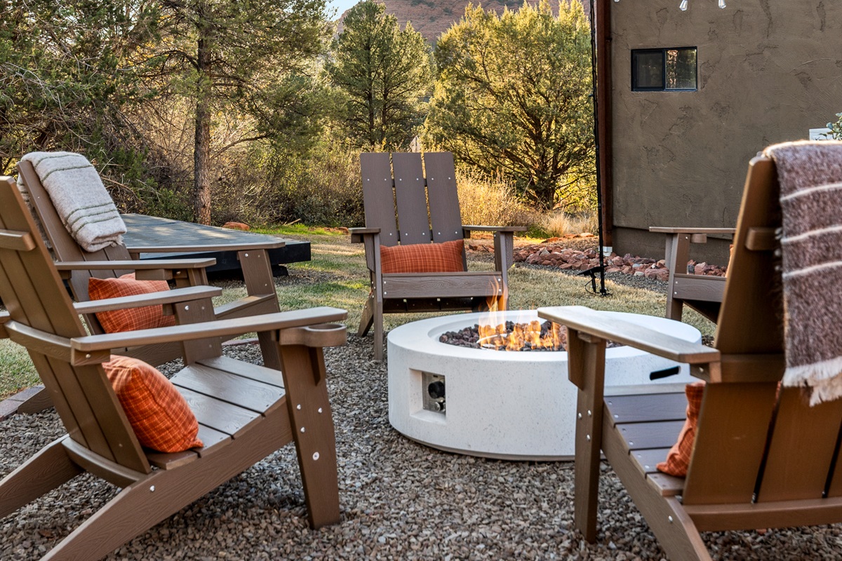 Settle into Adirondack chairs as the fire flickers, surrounded by desert trees and calm - an inviting space for conversation and evening unwinding.