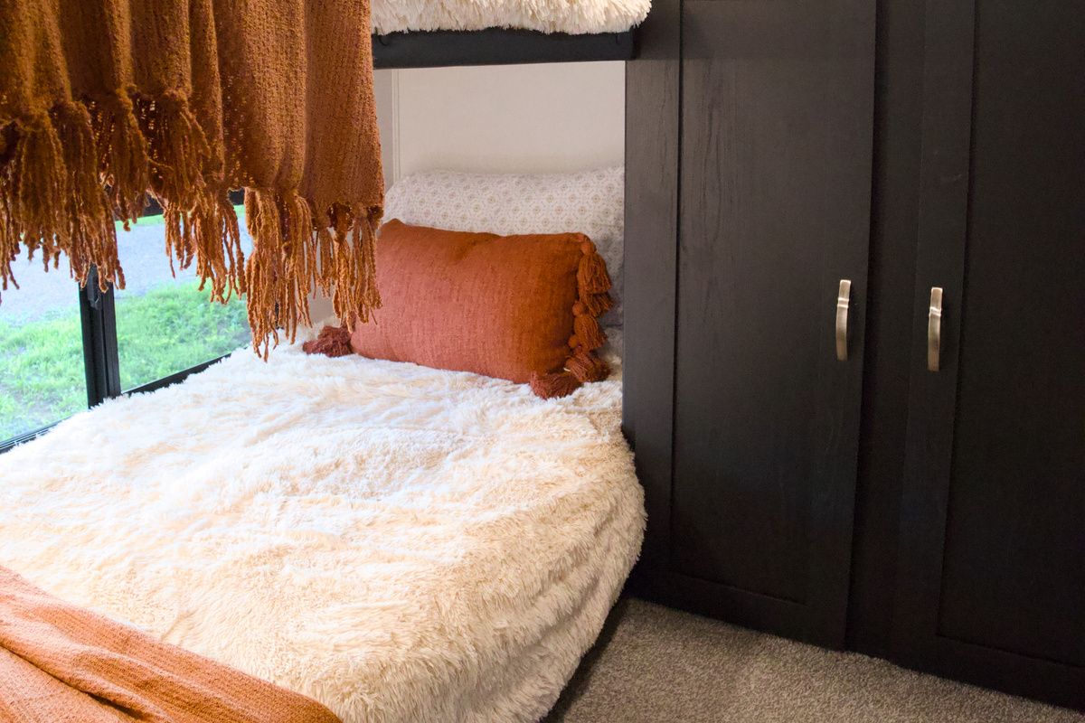 The bunk room has 4 bunks, each with their own window. 2 of the beds are 26.5" wide, so there's not much room for moving around.