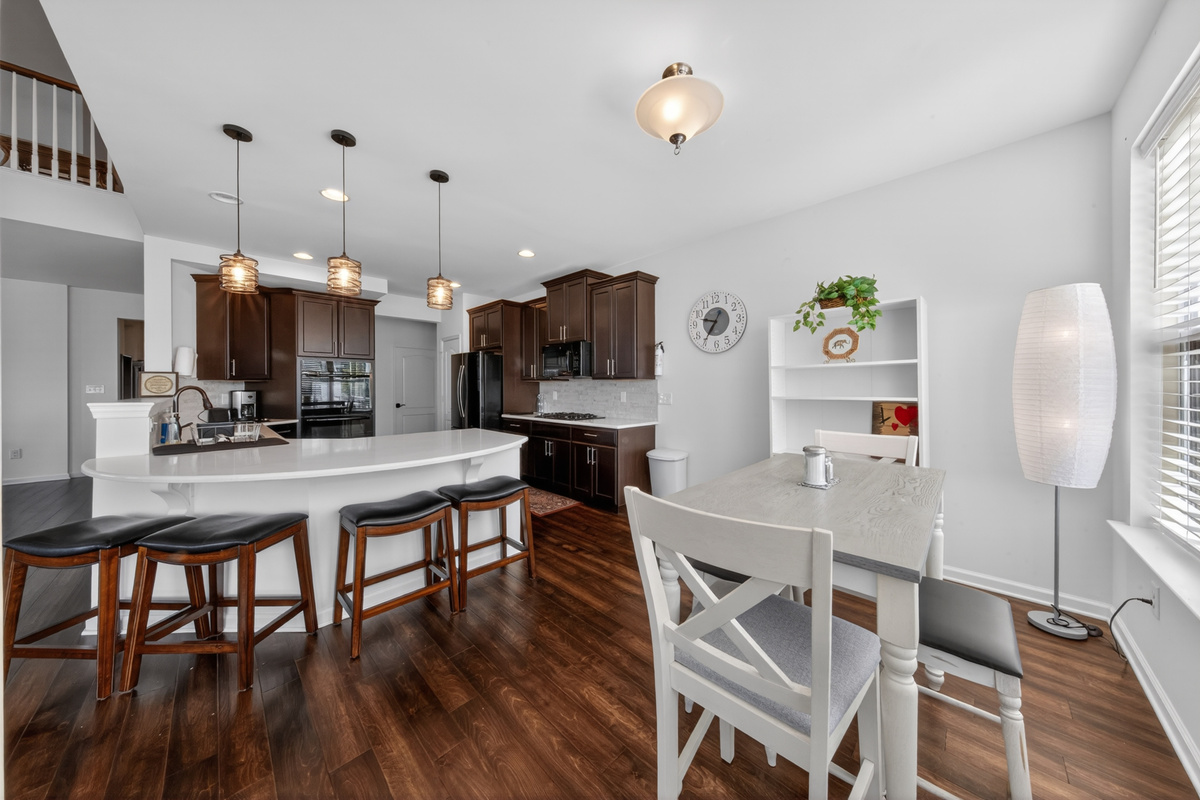 Granite island and morning dining nook offering versatile breakout workspaces.