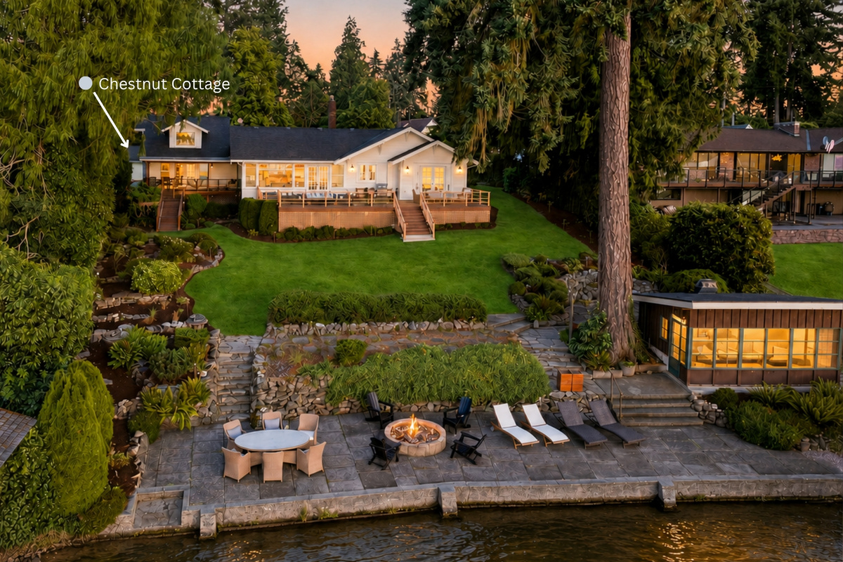 Viewed from the lake, Chestnut Cottage is on the left side of the main residence, with its private deck clearly visible. Haven unfolds across nearly an acre, with shared lawns, a glowing firepit, waterfront structures and 100 feet of shoreline.