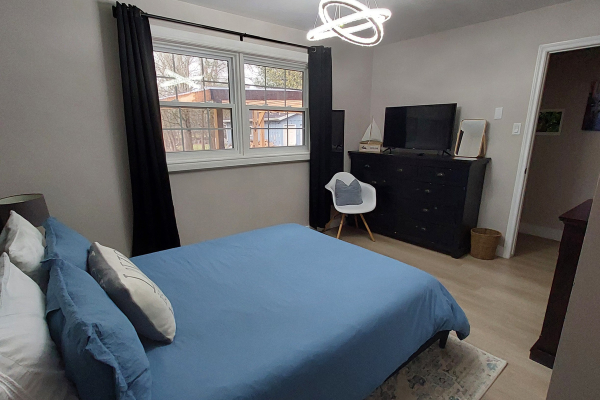 Bedroom 2: your quiet retreat with TV, dresser, closet, chair, USB lamps, electric fireplace and 2 plush robes for cozy nights in or a trip to the hot tub.
