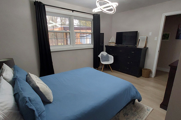 Bedroom 2: your quiet retreat with TV, dresser, closet, chair, USB lamps, electric fireplace and 2 plush robes for cozy nights in or a trip to the hot tub.