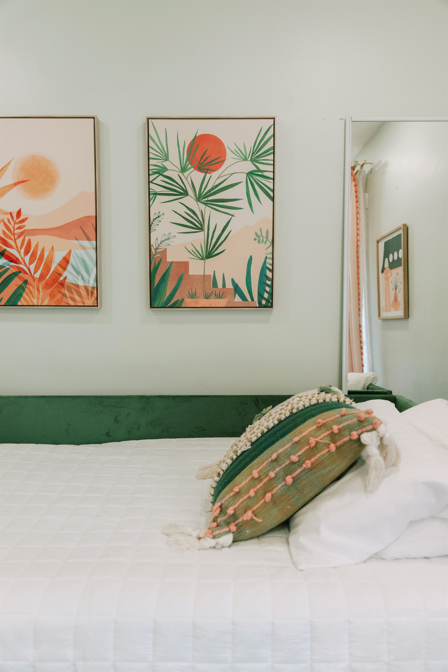 The third bedroom has a daybed and a pullout bed, garnished with colorful art throughout.