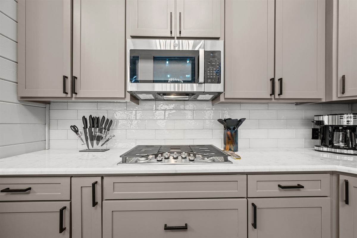 Every detail—down to the stainless steel appliances and cabinetry—adds a touch of modern comfort to this warm cabin retreat.