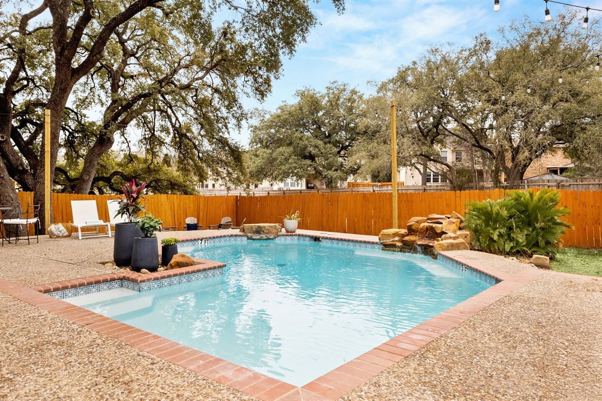 The spacious backyard with the large pool and hot tub will make you want to stay forever.