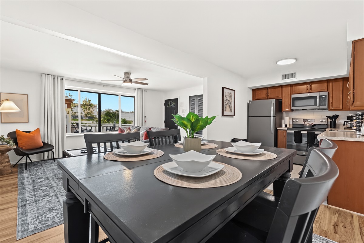 Enjoy meals with a view in this open-concept kitchen and dining area, flowing seamlessly into the bright and cozy living room.