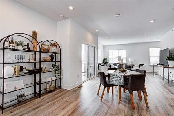 Enjoy a designed open-concept space with a modern kitchen equipped with quartz countertops, stainless steel appliances, and all essentials for home cooking. 