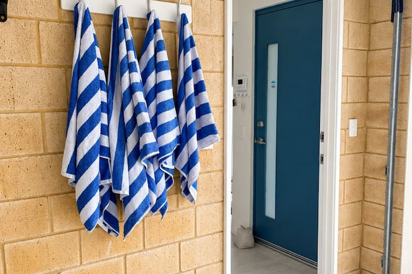 Grab a striped beach towel on your way out, with a set hanging ready on the hooks beside the internal garage entry, so there’s no need to pack your own for the beach or pool.