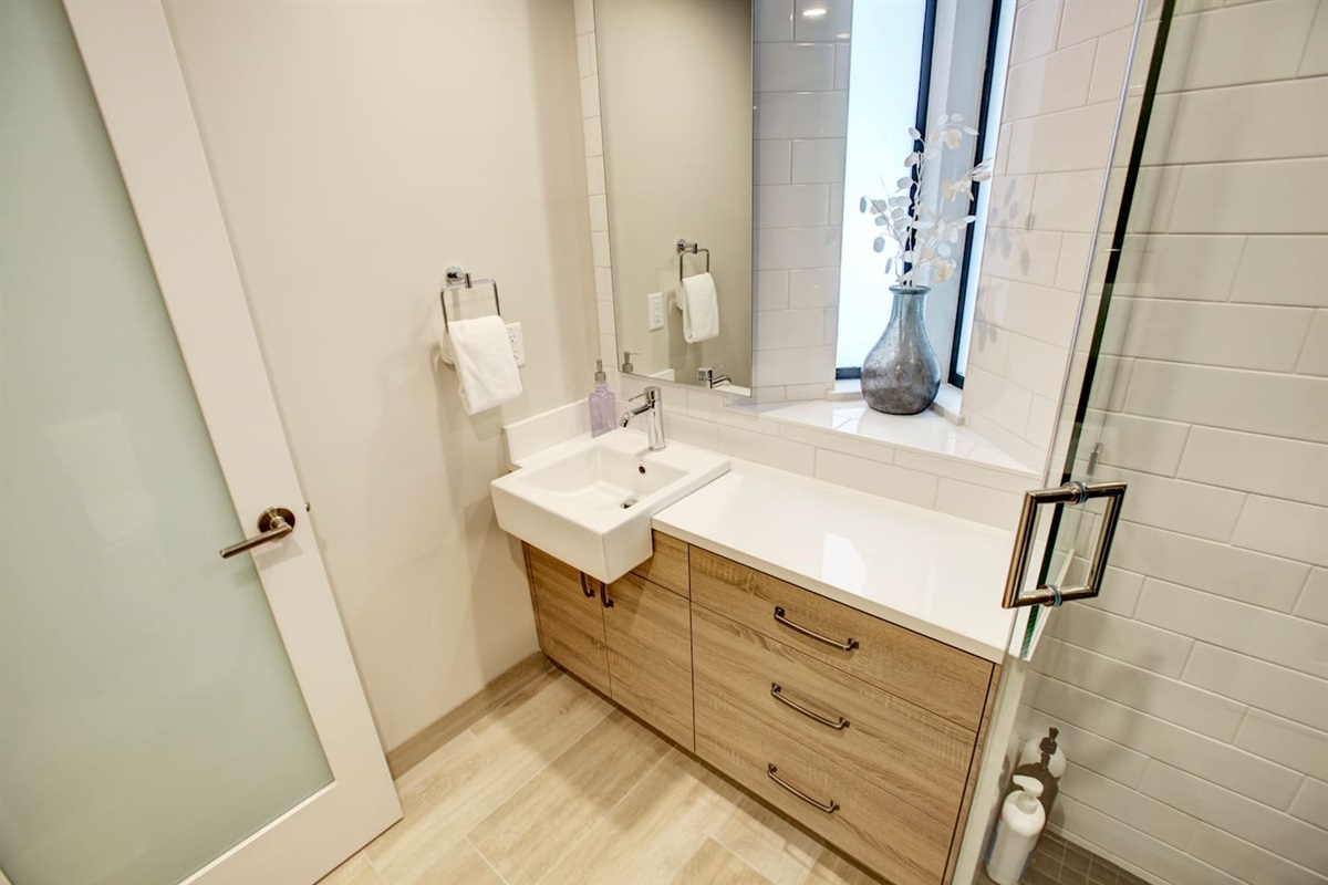The main floor bathroom vanity is equipped with powerful hair dryer,  body wash, shampoo, conditioner as well as towels, cleaning products and extra paper towel and toilet paper. 