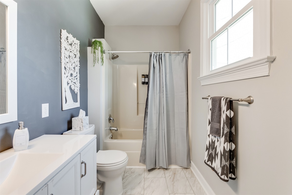 Bathroom 1 (Hallway): Fresh decor, elegant fixtures, and natural light create your perfect spa getaway!