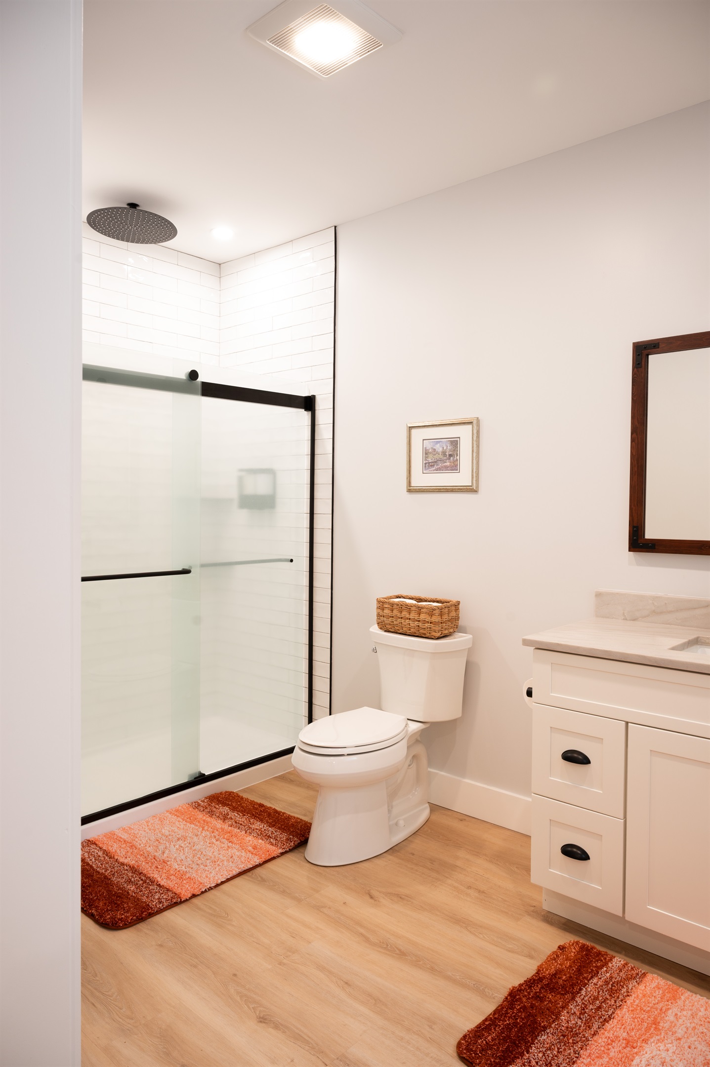 Shower w/ regular & rain shower head, toilet, and vanity