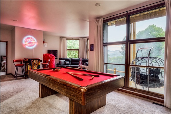 Pool table with panoramic mountain views — game nights with a view.
