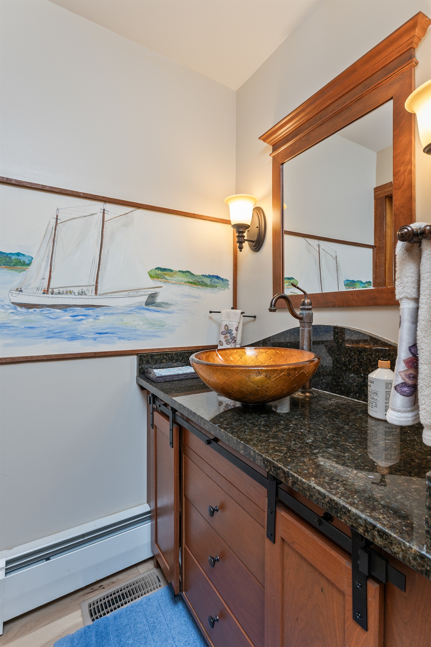 Stylish half bath with a granite vanity and modern vessel sink – perfect for guests on the go.