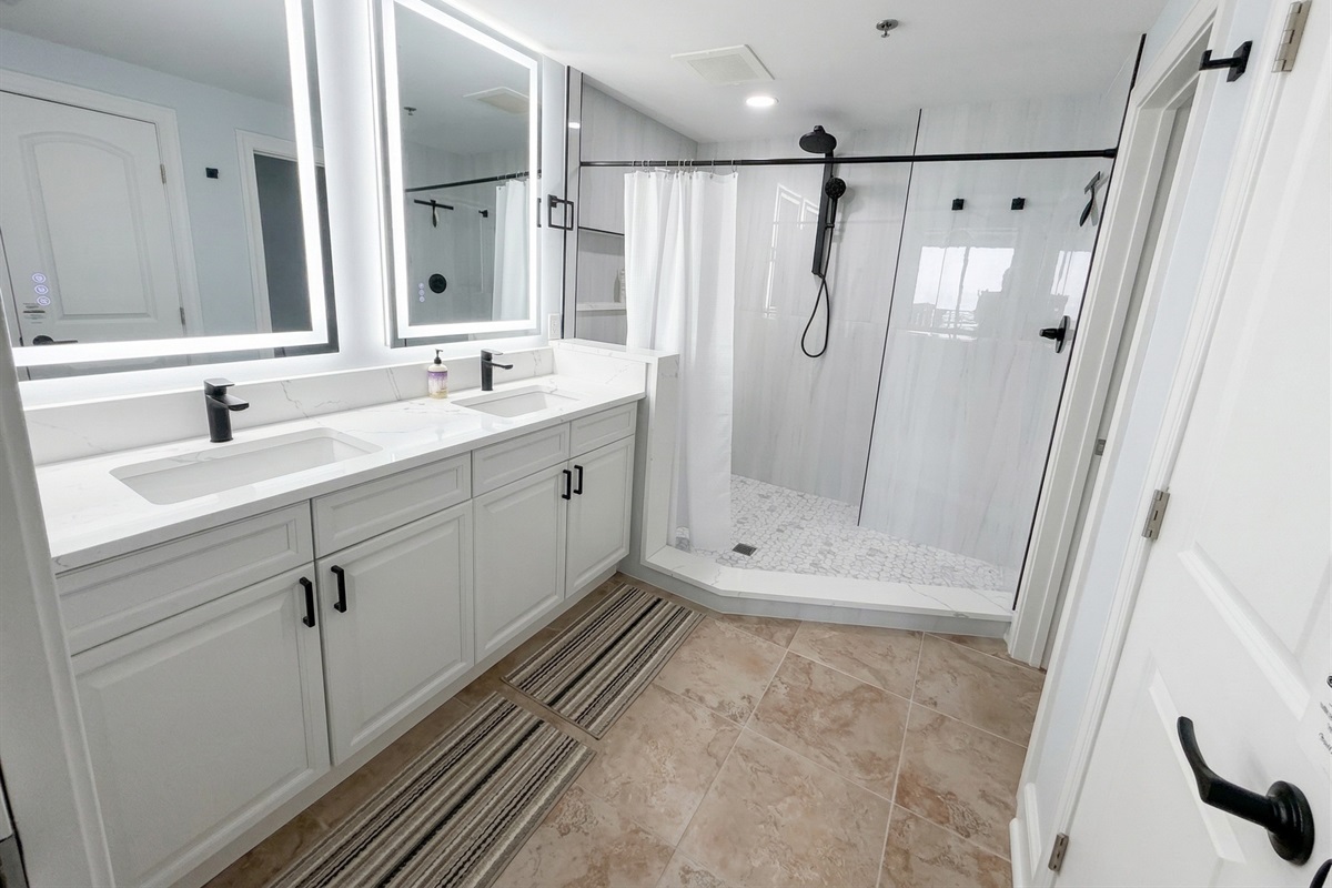 Start your day with plenty of space—double sinks, bright lighting, and a large walk-in tiled shower make mornings easy for everyone.