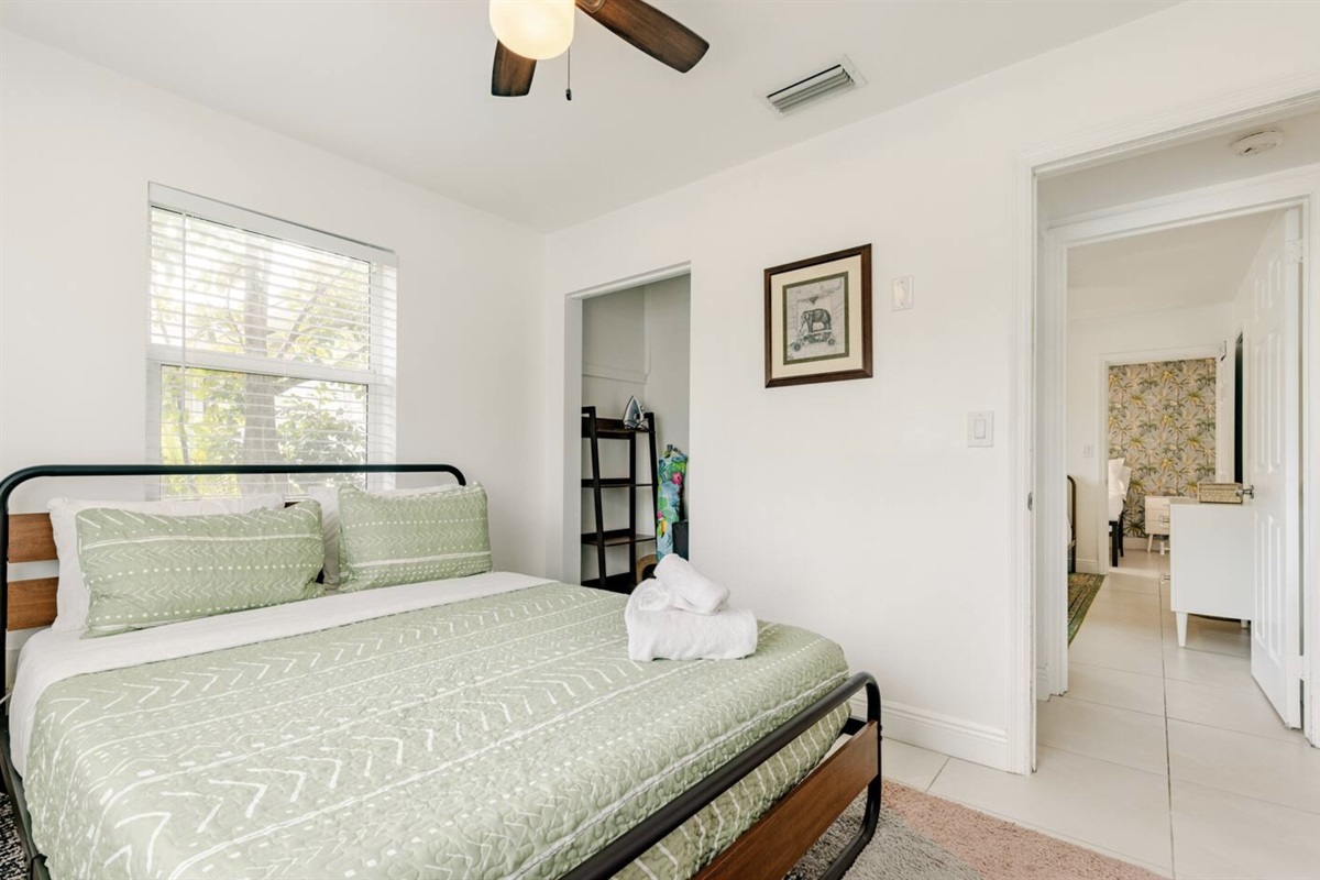 The second bedroom faces the front of the house and also jungle vibes, such as the elephant wall decor.