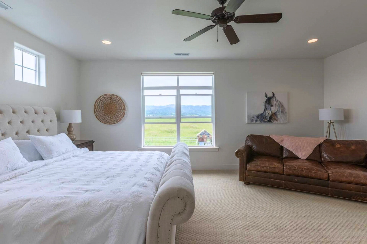 Primary suite with king bed, sleeper sofa, and stunning Teton views