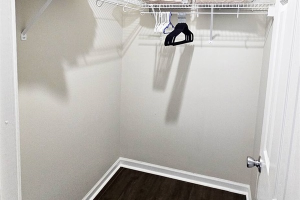 A nice-sized walk-in closet is attached to this room. There are extra hangers, linen, pillows, and blankets found here.