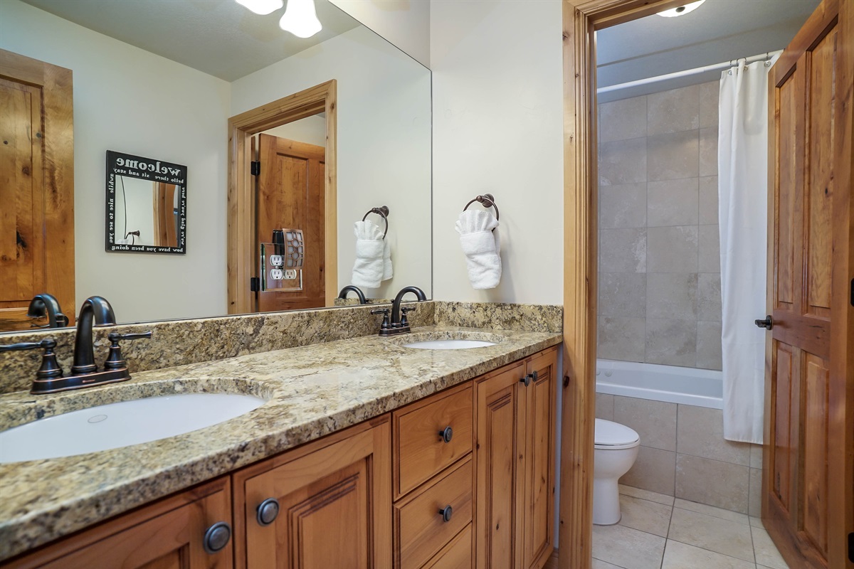 Full bathroom with double vanity and plenty of space for guests.