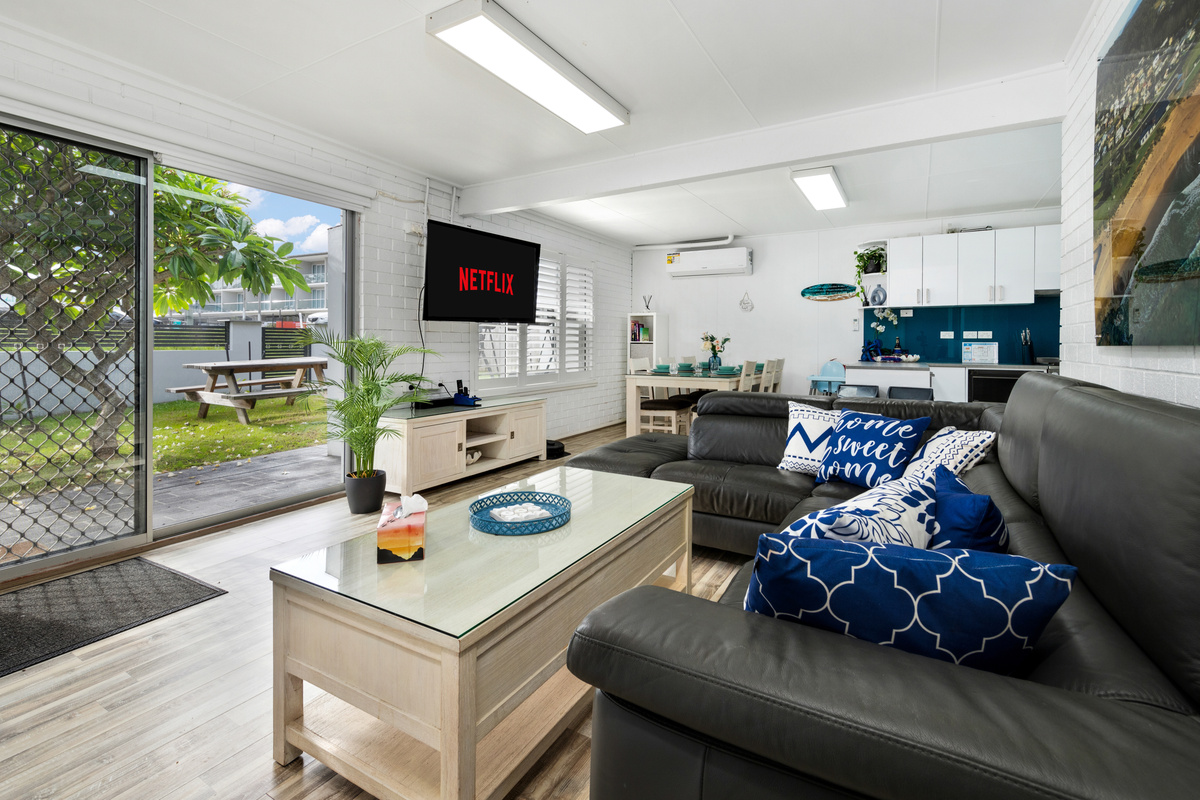 Two living areas make Skye’s Beach House flexible across both levels, with this downstairs lounge adding a separate space to spread out