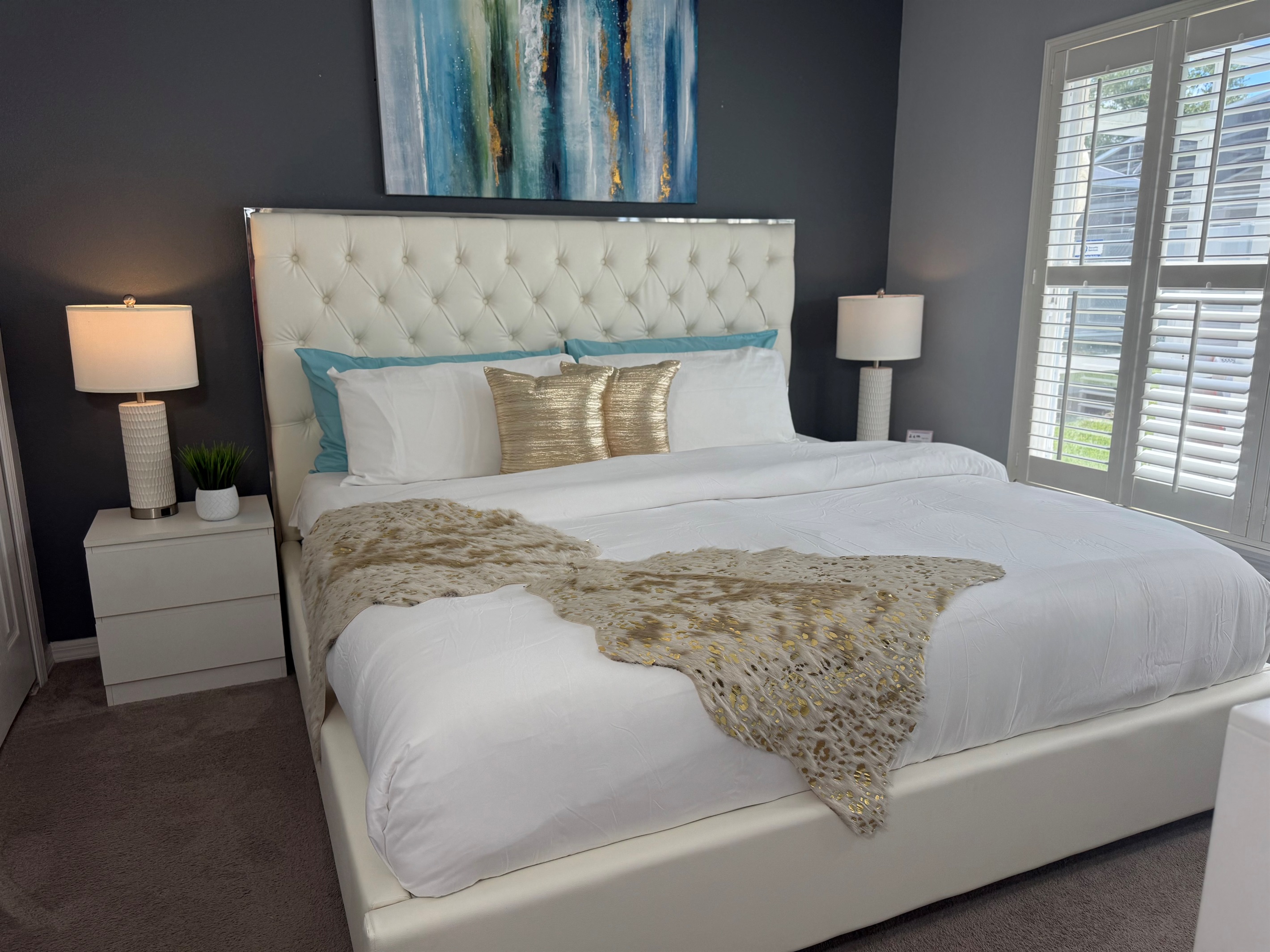 🏡 Your perfect getaway: a clean and relaxing king bedroom with soft bedding, ceiling fan, and pillow-top comfort