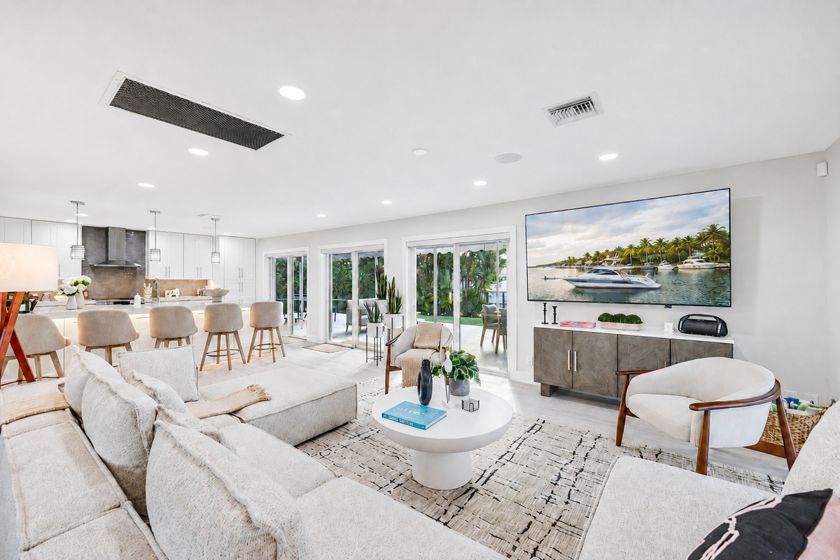 Settle into the spacious living room with a large sectional, big-screen TV, and sliding doors that keep the patio and pool close by.