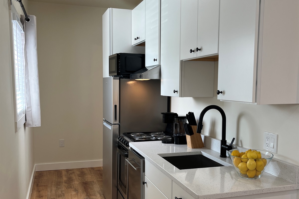 Kitchen area leading to full bathroom