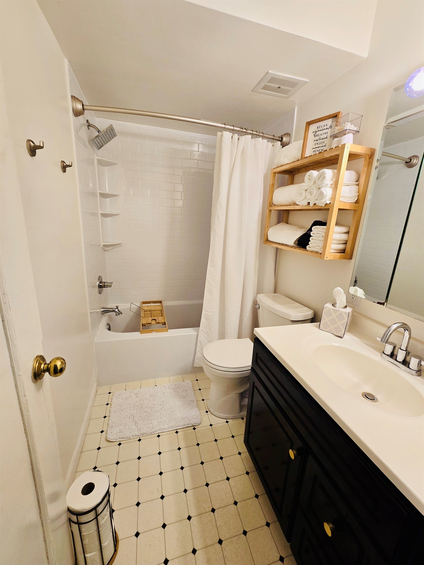 White, crisp, and spa-inspired—our bathroom features an oversized shower head, plush linens, and a bath tray ready for your book and beverage. Just add steam and serenity.