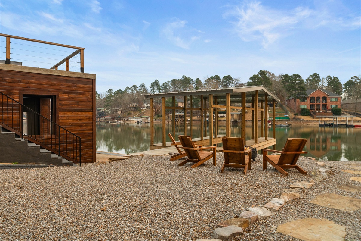 The firepit area invites guests to gather as evening settles in, creating the perfect setting for stories, laughter, and lakeside sunsets.