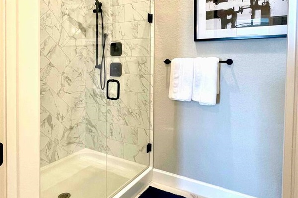 Master shower en-suite with overhead rainwater shower head as well as a hand wand shower head. Shampoo, conditioner, and body wash provided in all showers.