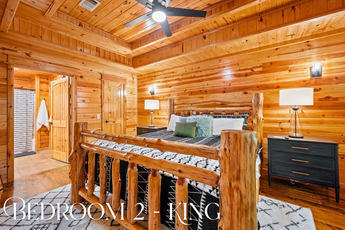 Bedroom 2 offers another king bed with a custom log frame and cozy bedding for a restful retreat.