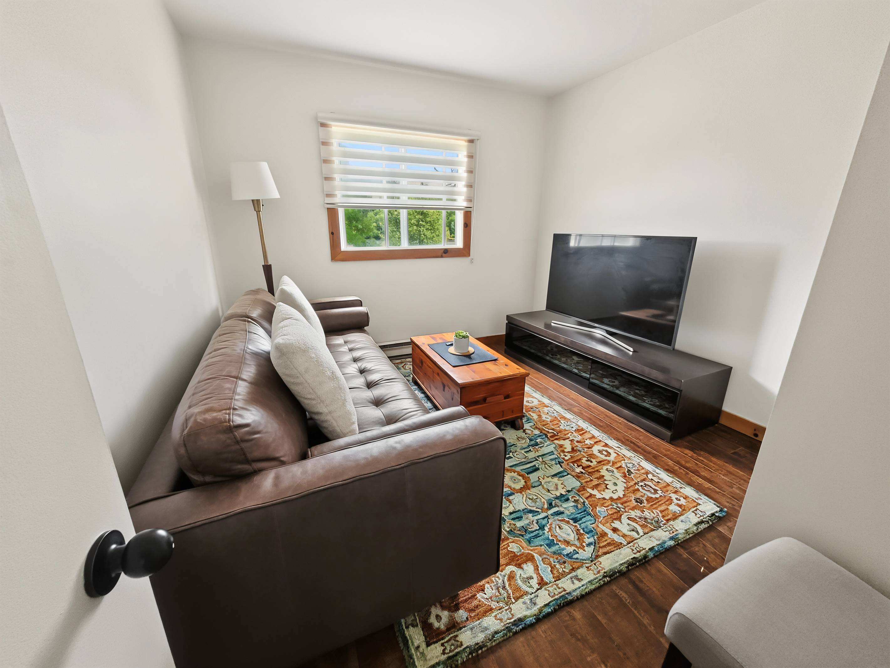 Entertainment area with large smart TV and comfortable seating