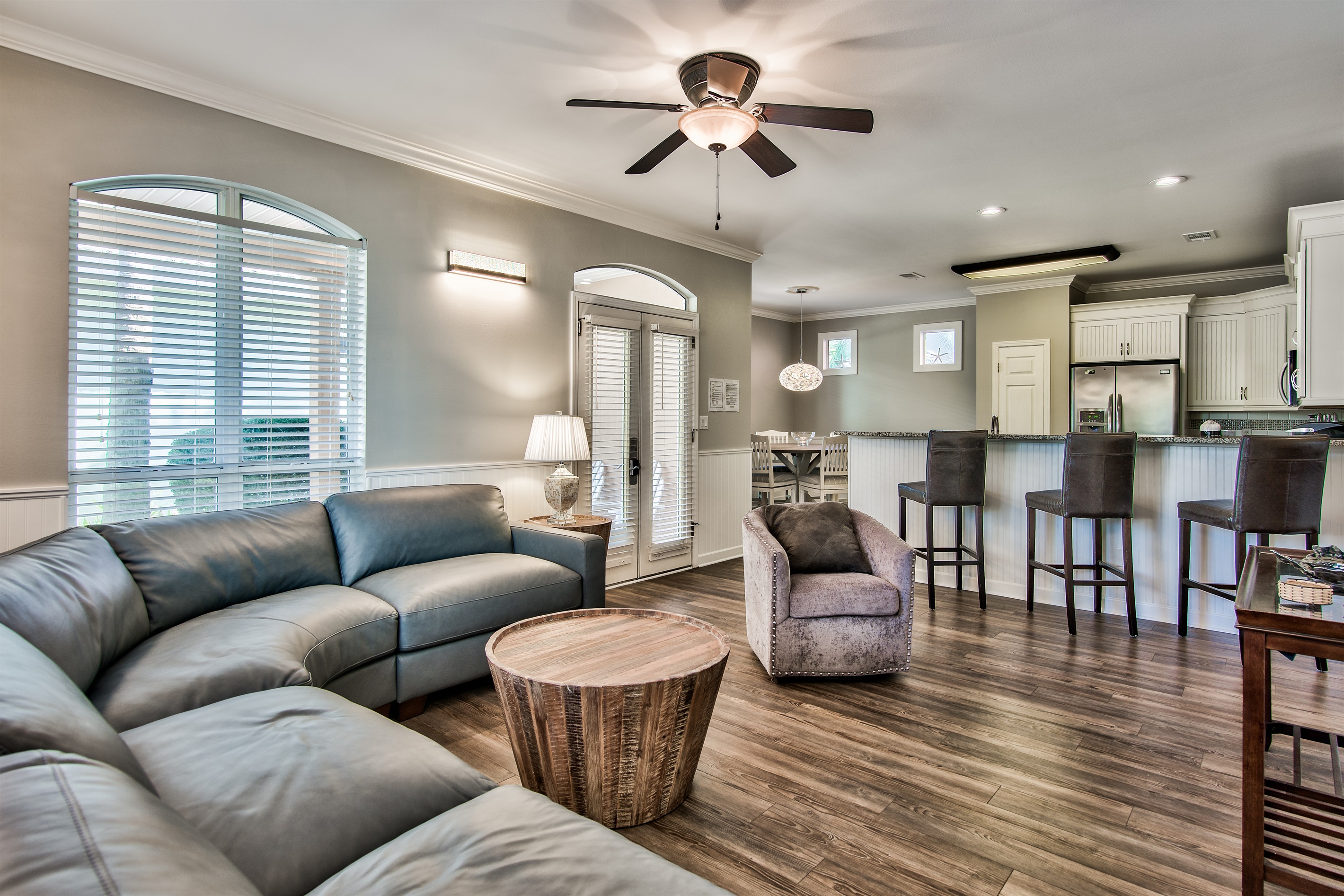 Open‑concept living area with vaulted ceilings and abundant natural light