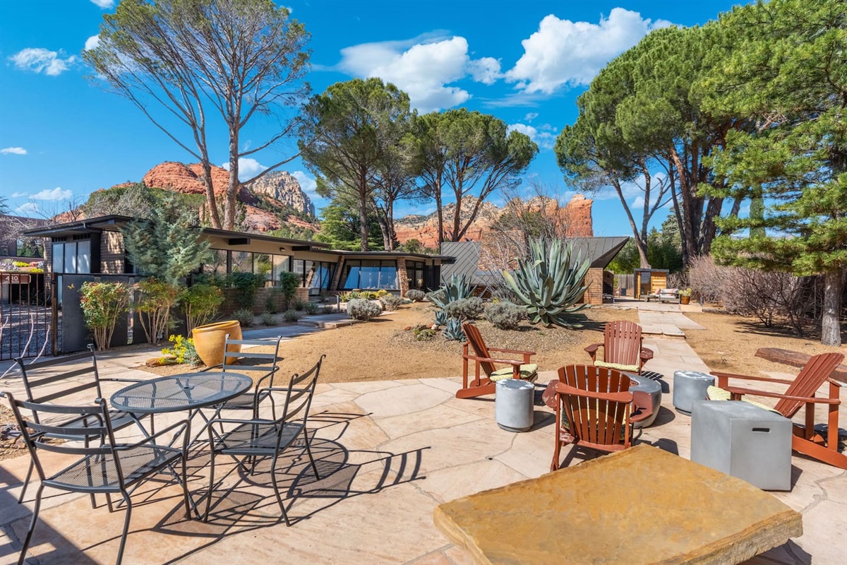 Expansive desert retreat with stunning red rock views, mature trees, and thoughtfully designed outdoor living spaces — complete with fire pit seating and patio dining areas to fully enjoy the beautiful surroundings.