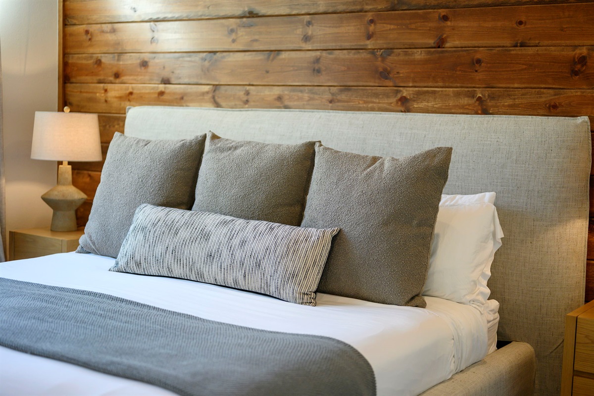 King Suite 3 - Large and spacious suite with cedar wood paneling, designer finishes, smart TV, premium king mattress, and luxury bedding. Includes stunning views of the hardwood forest. 