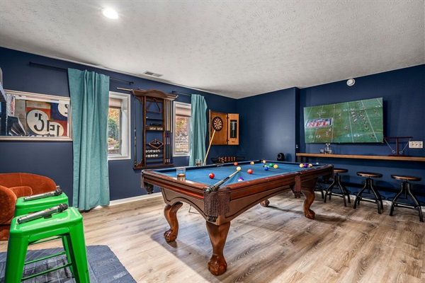 A cozy game room made for late-night laughs, tournament-style pool battles, and hanging out together.