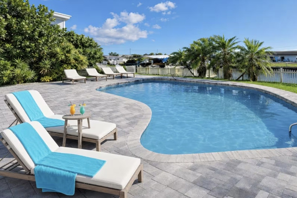 Resort-style heated pool overlooking the waterfront with premium loungers