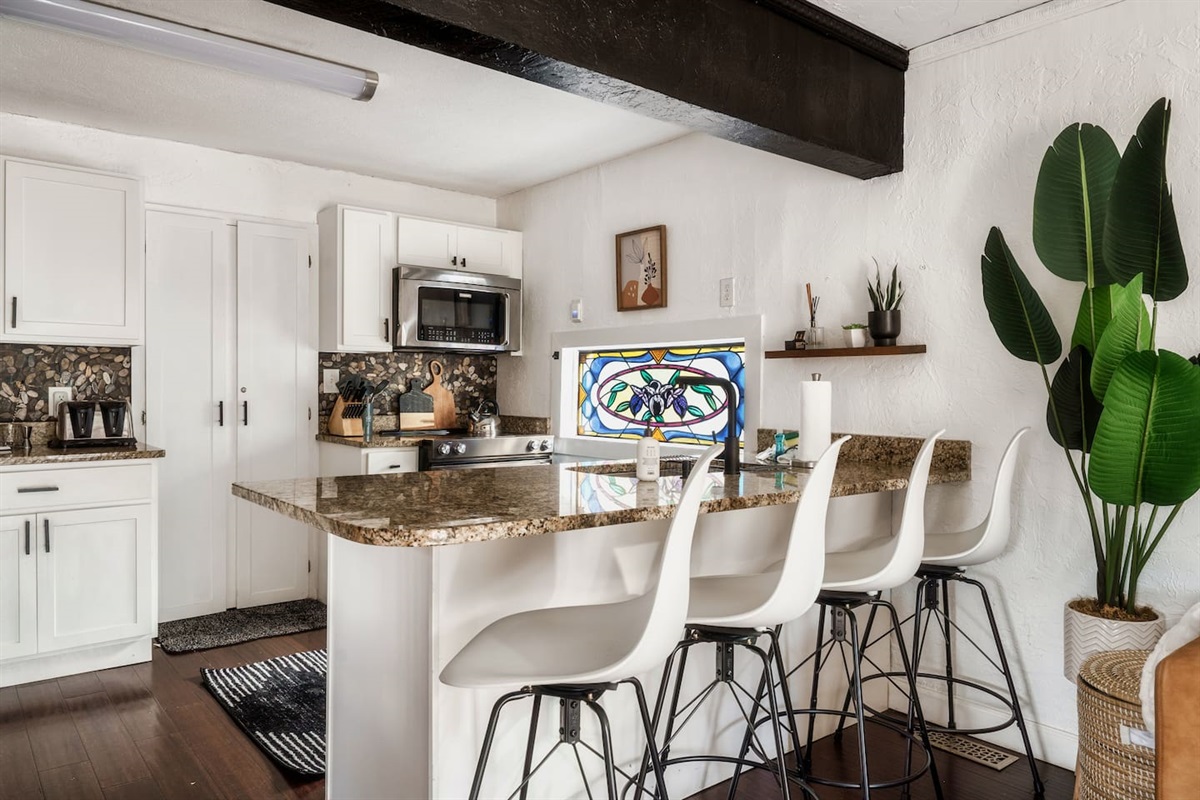 Unique kitchen with modern appliances and stained glass