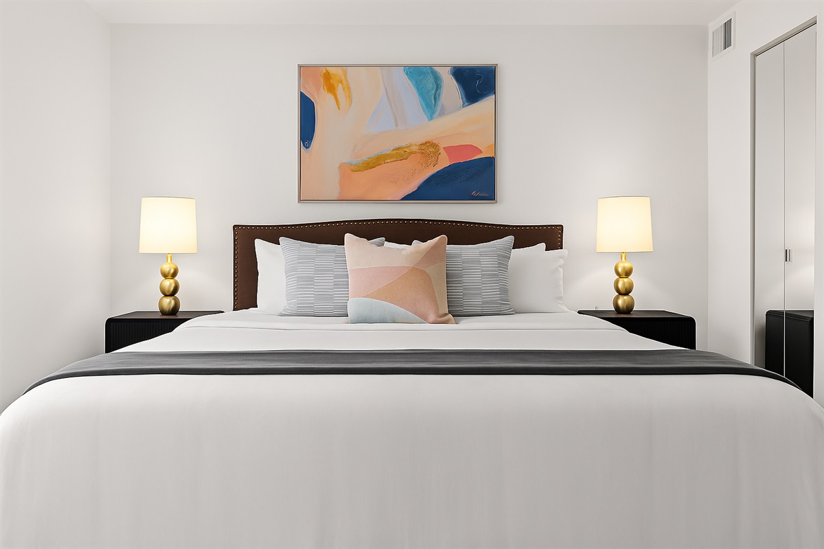 Rest easy in a plush king bed with stylish lighting, soft linens, and a relaxing atmosphere.