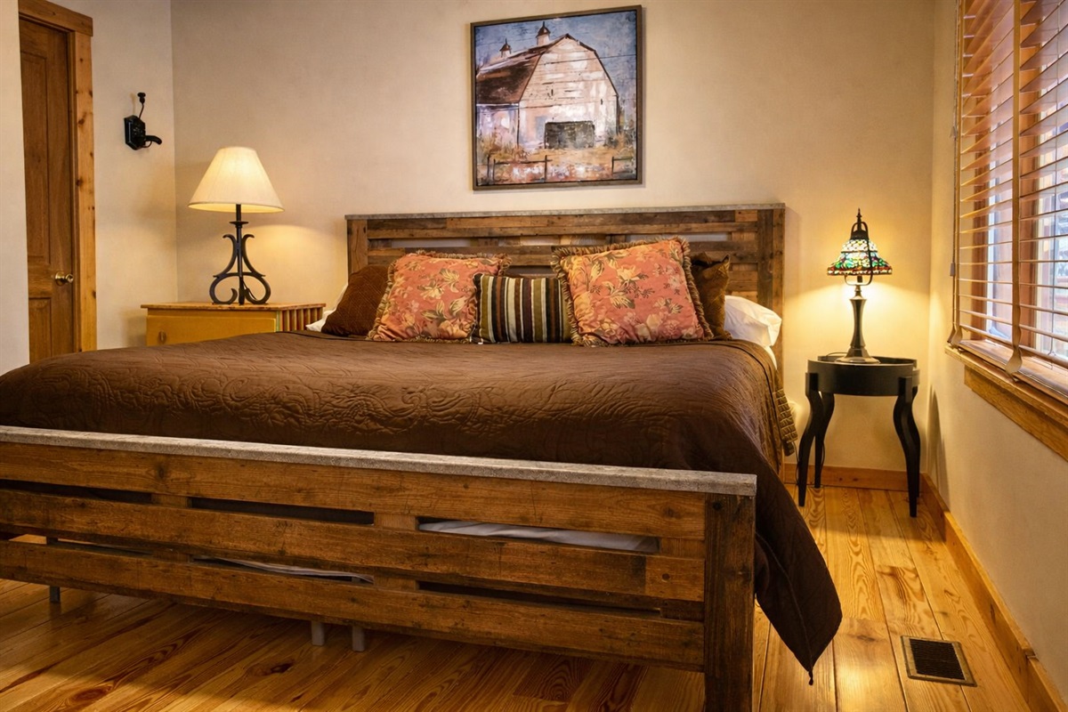 Drift off in this cozy cabin bedroom, where warm wood tones and soft lighting create the perfect mountain retreat.